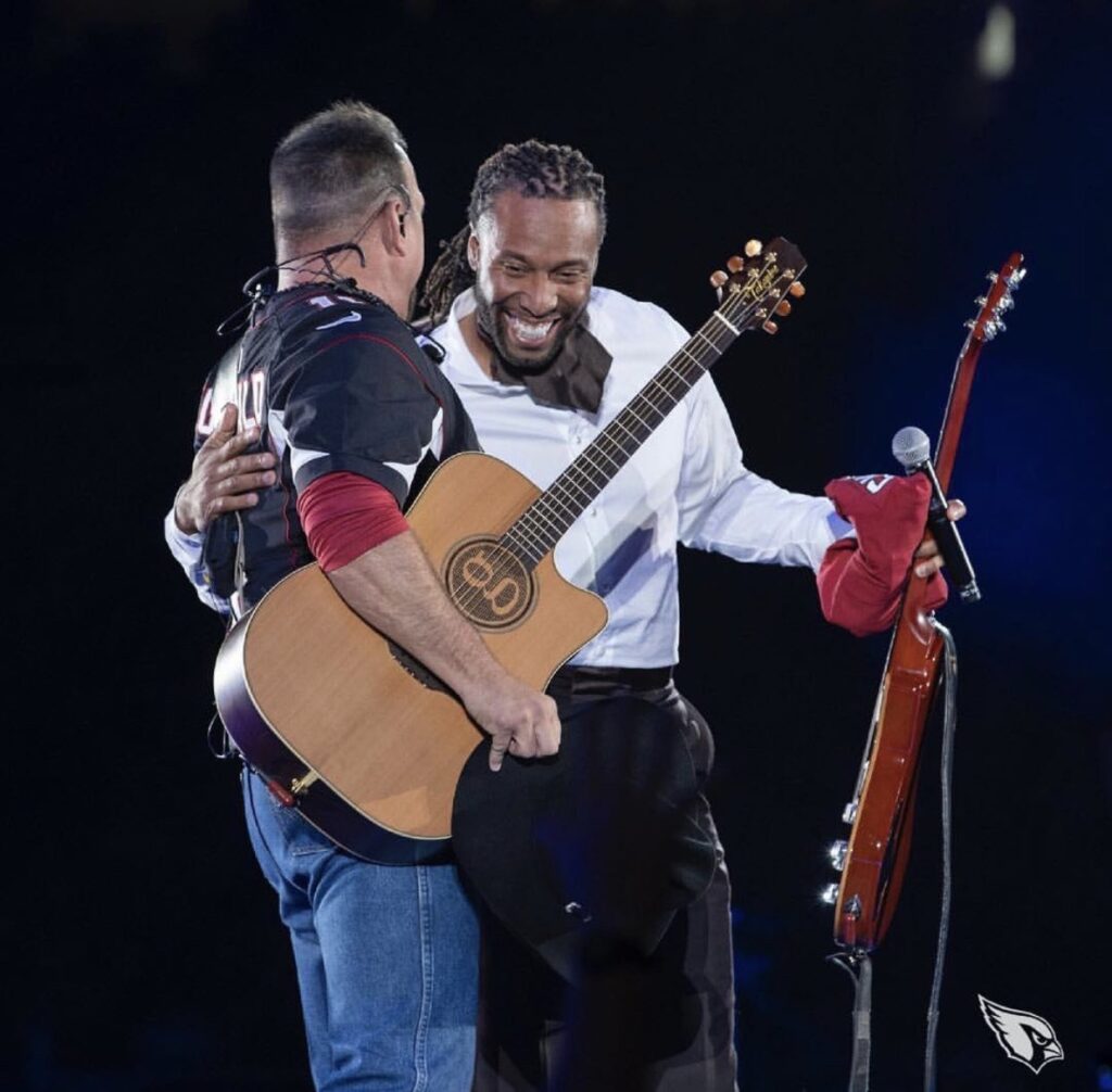 Larry Fitzgerald presents Garth Brooks with a custom jersey during Brooks' performance at State Farm Stadium in Glendale, AZ on March 23, 2019. Photo courtesy of the artist.